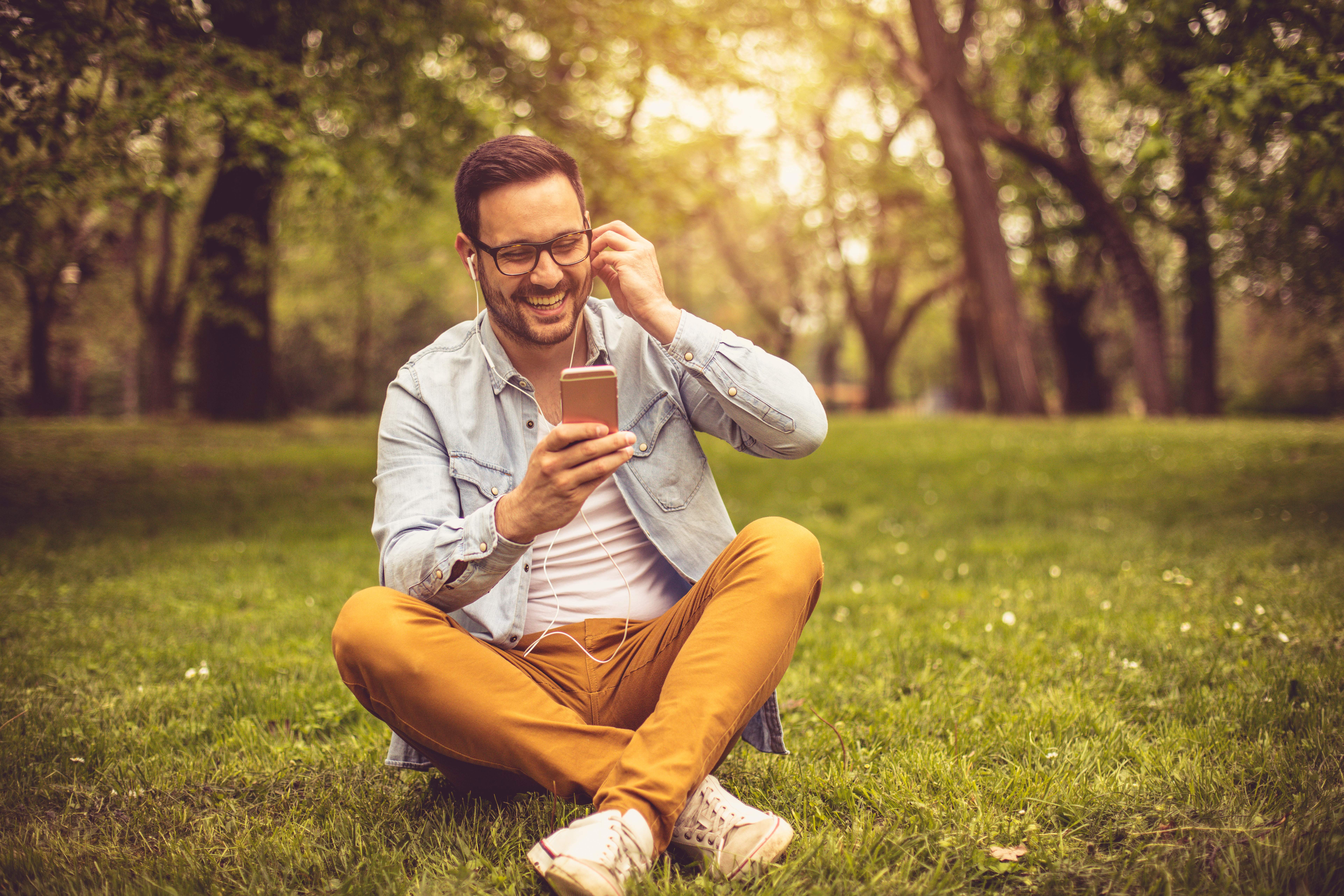 man listen to music at park